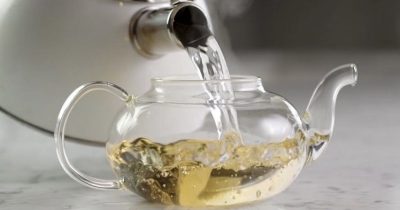 Water being poured into a tea pot